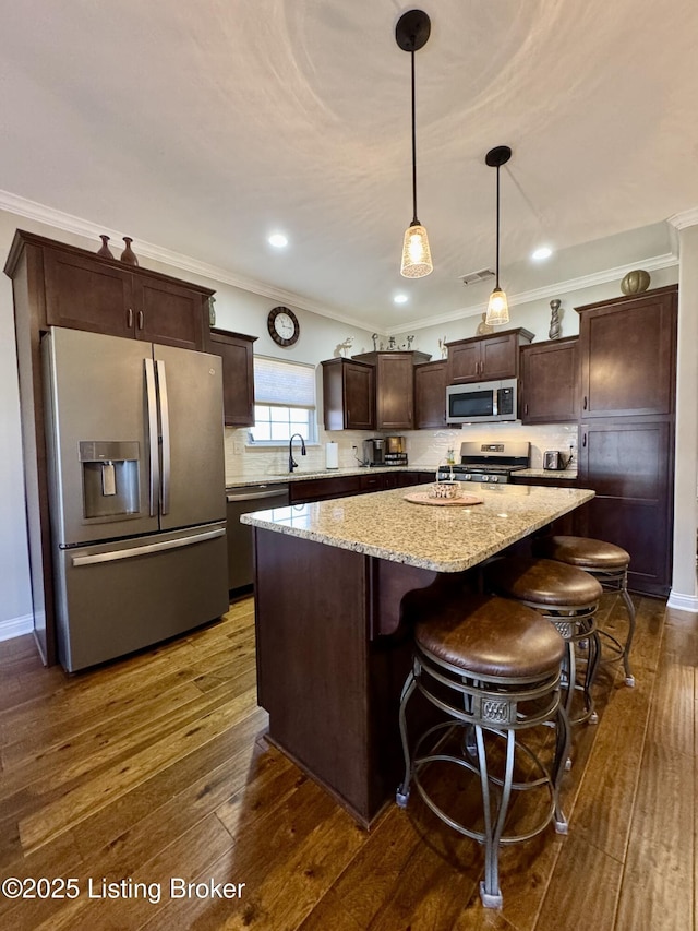 kitchen featuring a sink, dark brown cabinets, appliances with stainless steel finishes, and dark wood-style flooring