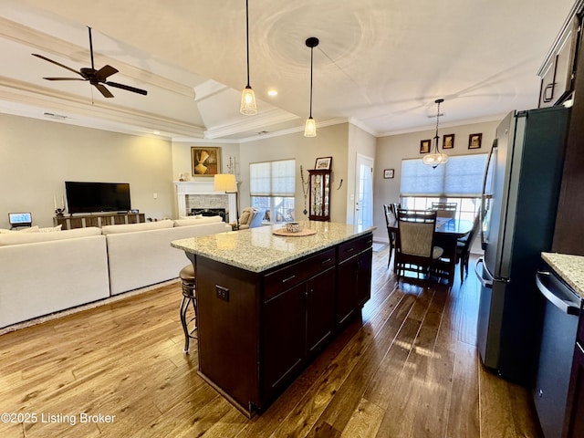 kitchen with dark wood-style floors, ornamental molding, a healthy amount of sunlight, and stainless steel appliances