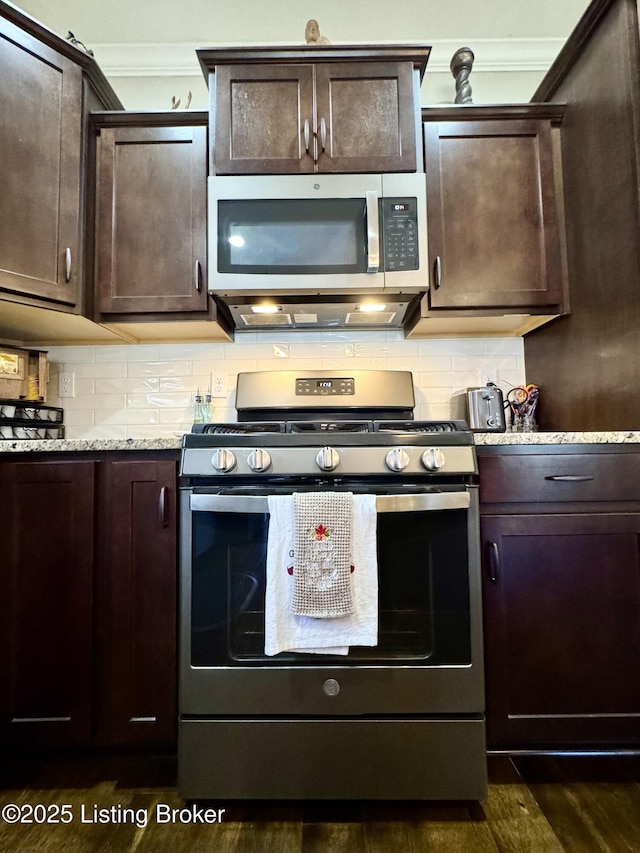 kitchen with decorative backsplash, dark brown cabinetry, and stainless steel appliances