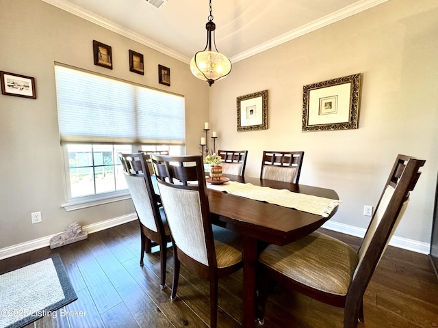 dining room featuring dark wood-type flooring, baseboards, and ornamental molding