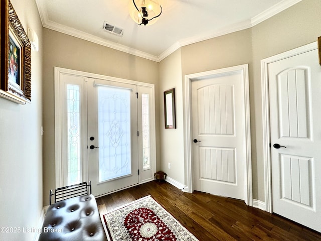 foyer featuring visible vents, ornamental molding, and dark wood-style flooring