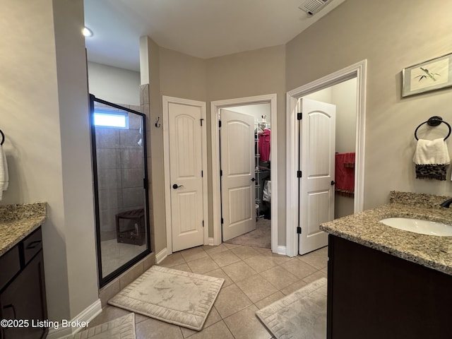 full bath with visible vents, a stall shower, and vanity