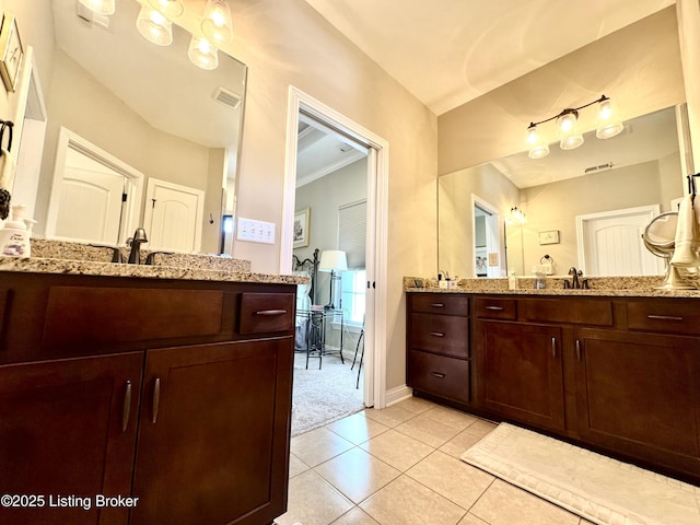 bathroom with baseboards, visible vents, two vanities, a sink, and tile patterned flooring