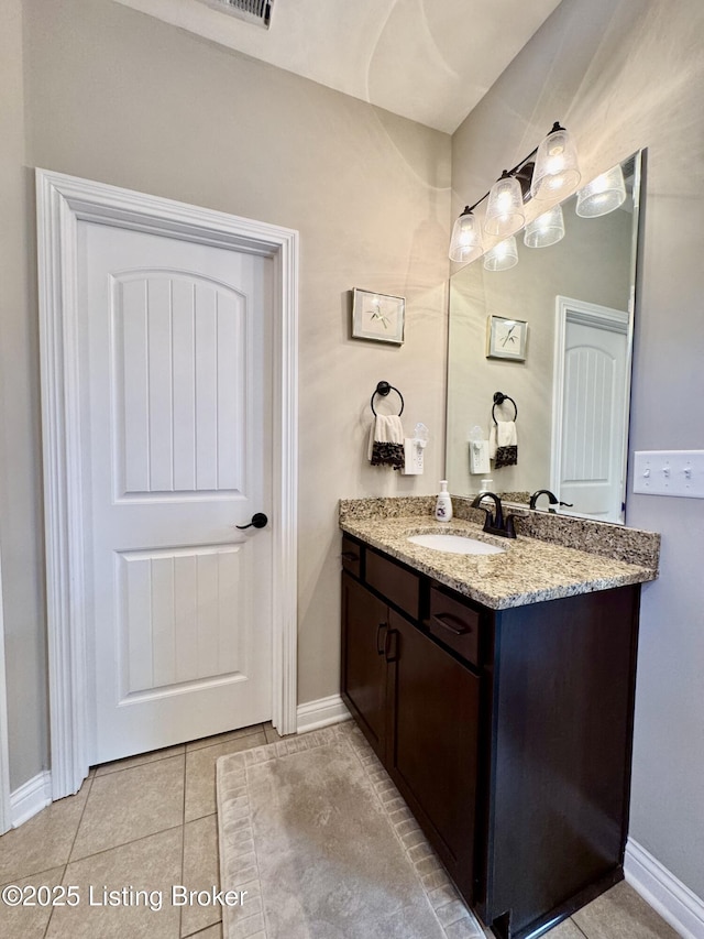 bathroom featuring tile patterned floors, vanity, and baseboards