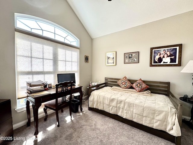 carpeted bedroom featuring baseboards and vaulted ceiling