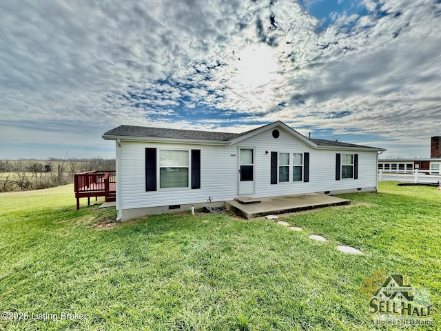 back of house with crawl space, a patio, and a yard