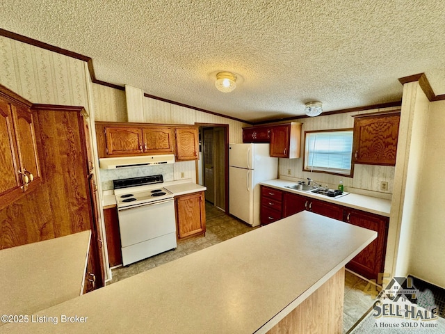 kitchen with white appliances, wallpapered walls, a sink, crown molding, and exhaust hood