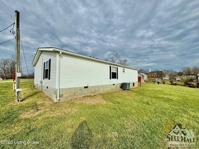 back of property with crawl space, a lawn, and central AC