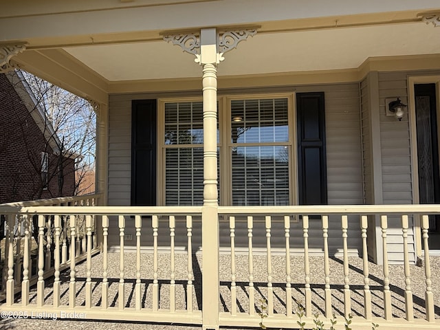 view of exterior entry with a porch