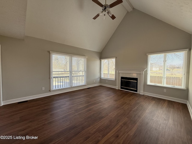 unfurnished living room with dark wood-style floors, visible vents, beam ceiling, ceiling fan, and a tile fireplace
