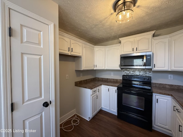 kitchen featuring dark countertops, stainless steel microwave, black range with electric cooktop, and dark wood-style floors