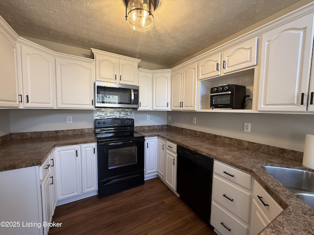 kitchen with black appliances, a sink, dark countertops, white cabinetry, and dark wood-style flooring