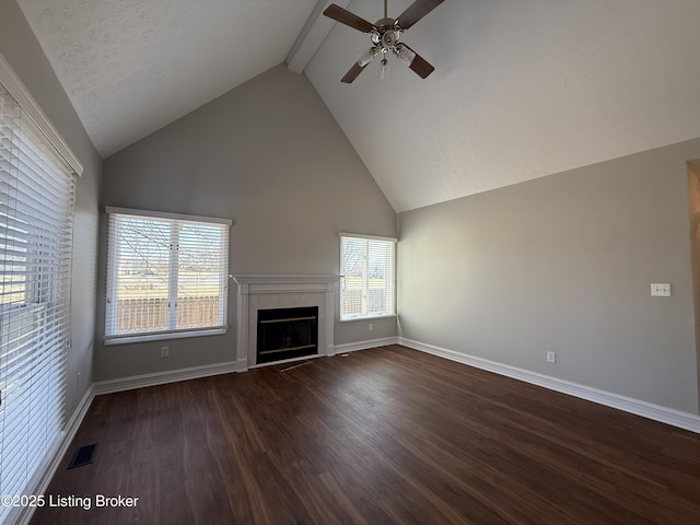 unfurnished living room featuring visible vents, beam ceiling, dark wood-type flooring, a fireplace, and baseboards