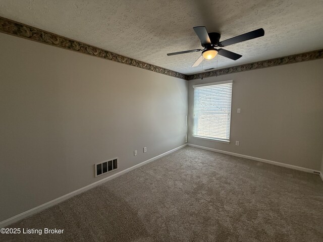 unfurnished room featuring baseboards, visible vents, ceiling fan, a textured ceiling, and carpet flooring