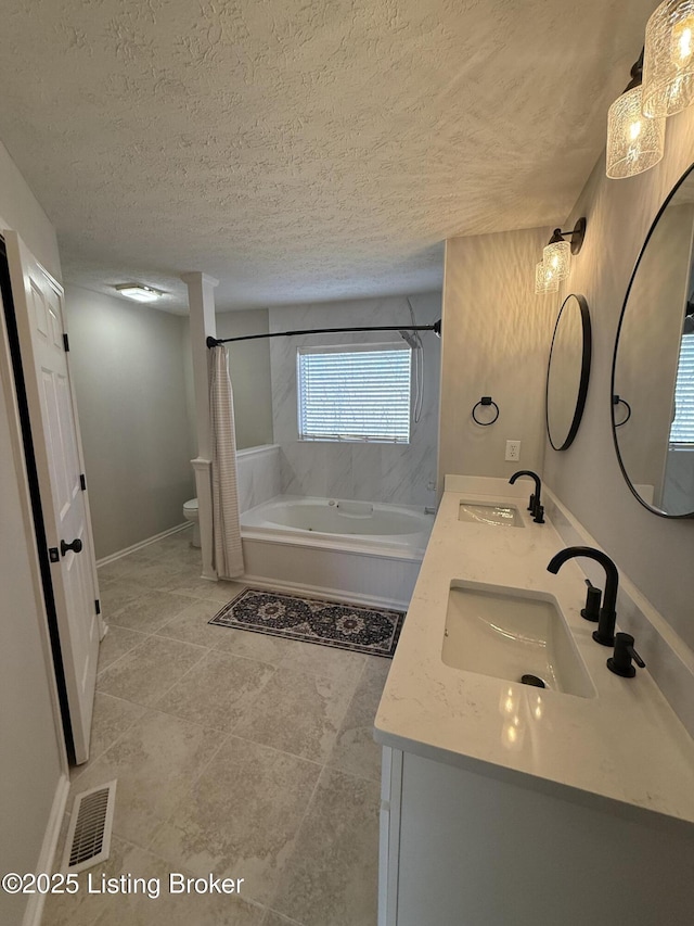 full bathroom featuring a sink, visible vents, shower / bathtub combination with curtain, and a textured ceiling