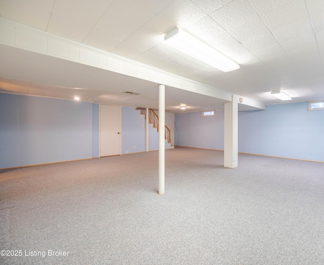 basement with stairway, carpet flooring, and visible vents