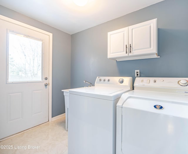 laundry area featuring washing machine and dryer and cabinet space