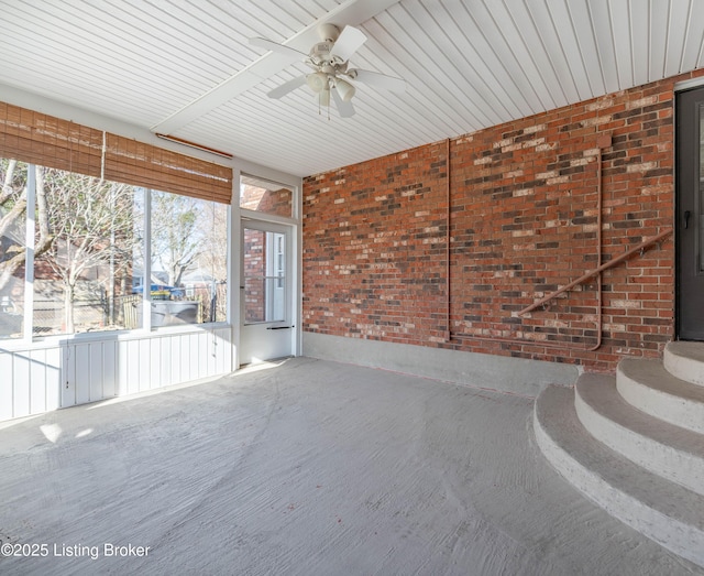 unfurnished sunroom featuring a wealth of natural light and ceiling fan