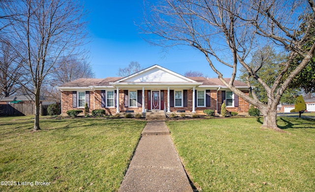 view of front facade featuring brick siding, a front yard, and fence