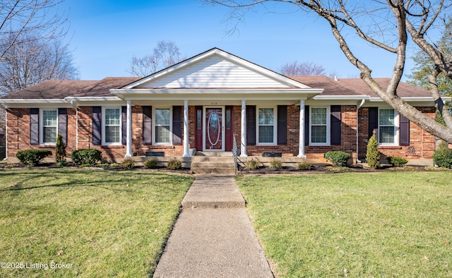 view of front facade with brick siding, a porch, and a front yard