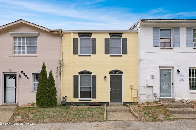 townhome / multi-family property with brick siding