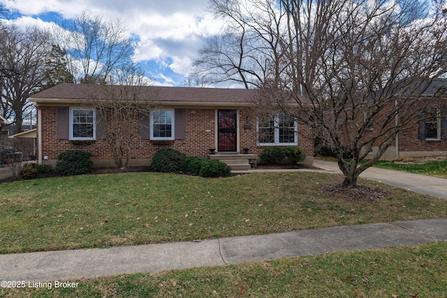 ranch-style home featuring brick siding and a front lawn