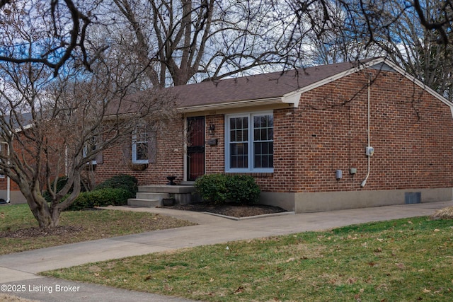 ranch-style house featuring brick siding