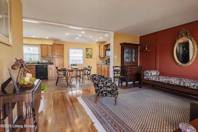 living room with light wood finished floors, plenty of natural light, and recessed lighting