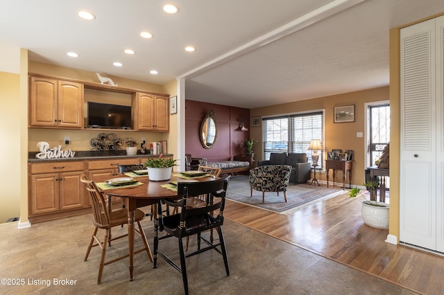 dining room with recessed lighting, baseboards, and light wood finished floors