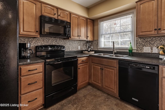 kitchen featuring black appliances, dark countertops, backsplash, and a sink