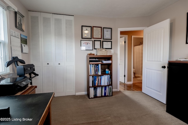 carpeted office space with baseboards