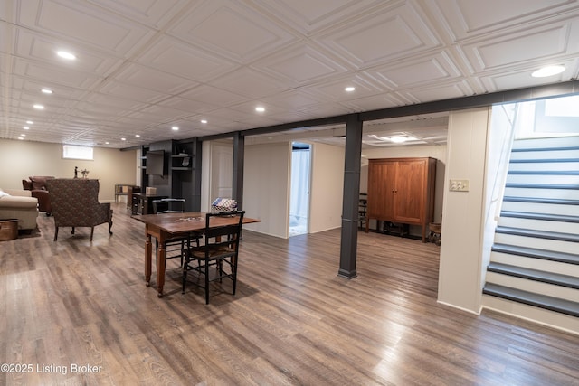 dining area featuring recessed lighting, an ornate ceiling, wood finished floors, and stairs