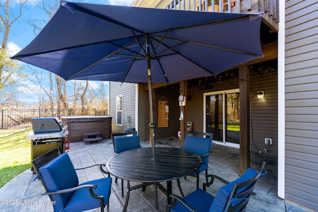 view of patio / terrace with outdoor dining space, a grill, fence, and a hot tub