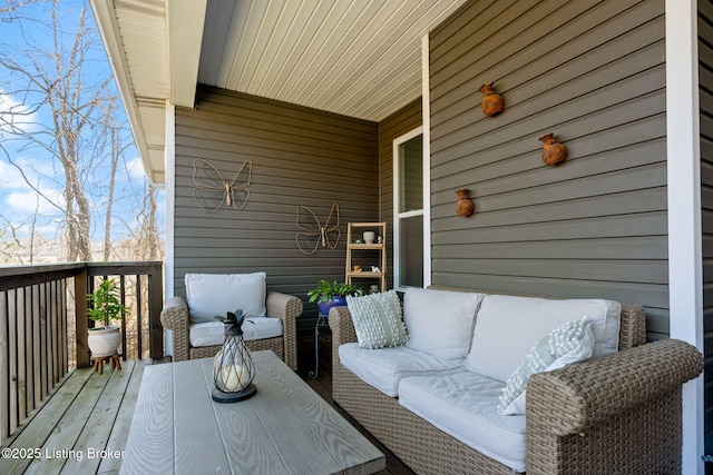 wooden deck with an outdoor living space