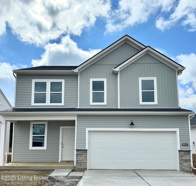 view of front of house with a porch, an attached garage, stone siding, and driveway