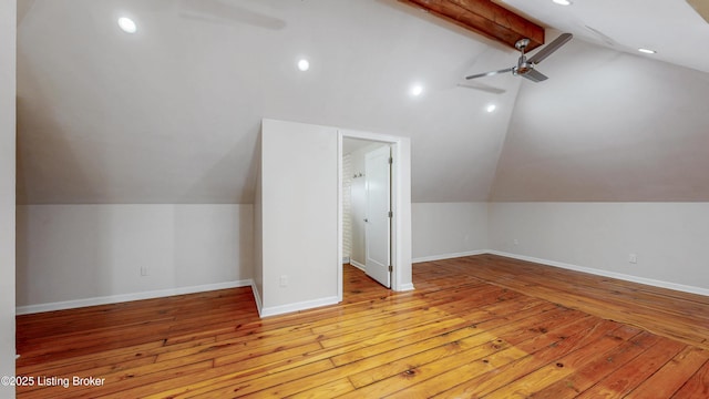 additional living space with baseboards and hardwood / wood-style flooring