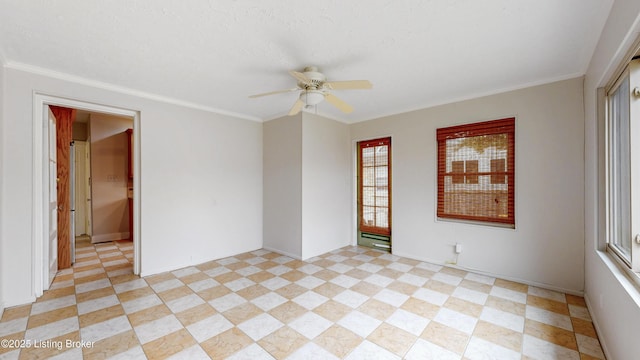 unfurnished room featuring a ceiling fan and ornamental molding