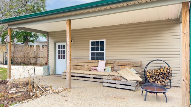 view of patio featuring a fire pit and fence