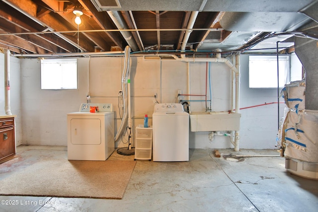 below grade area featuring a sink and washing machine and dryer