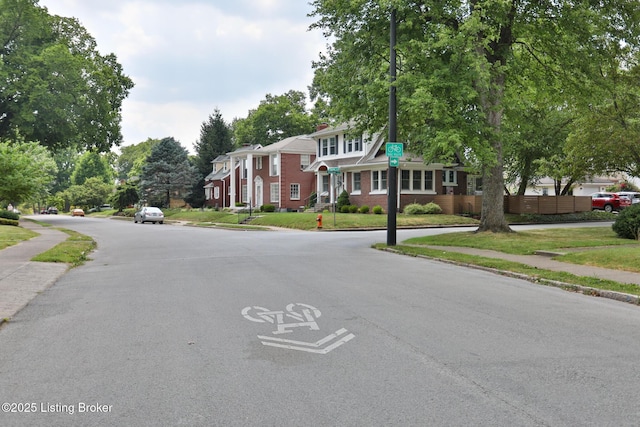 view of street with a residential view, curbs, and sidewalks