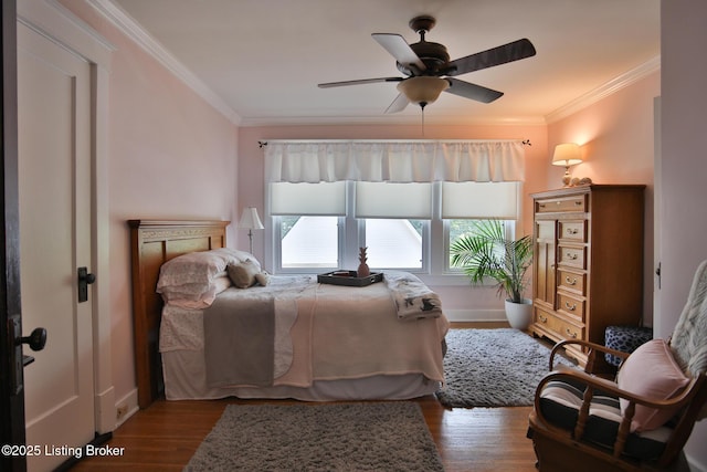 bedroom with crown molding, ceiling fan, and wood finished floors