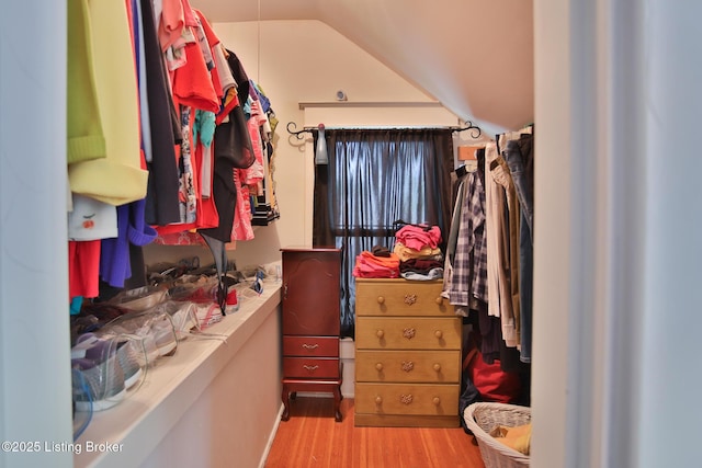 walk in closet featuring lofted ceiling and wood finished floors