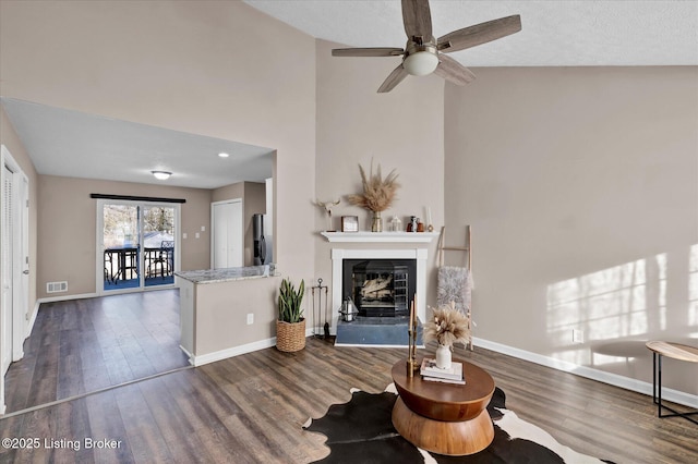 living area with visible vents, baseboards, and wood finished floors