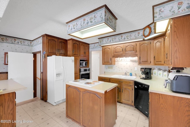 kitchen with light floors, wallpapered walls, stainless steel appliances, and a sink