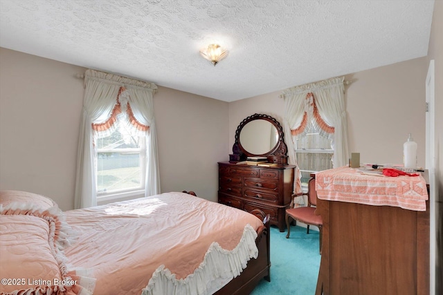 bedroom with a textured ceiling and carpet