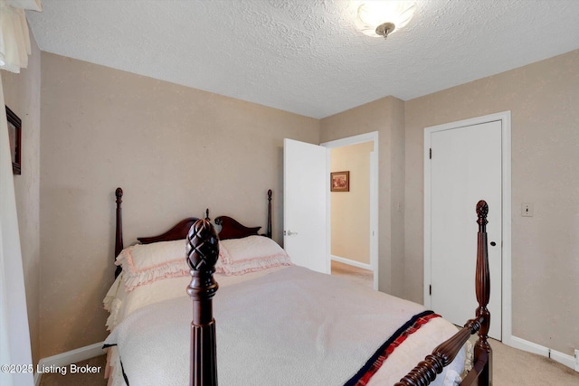 bedroom with a textured ceiling, baseboards, and light carpet