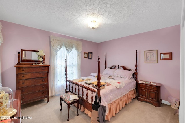 bedroom with light carpet and a textured ceiling