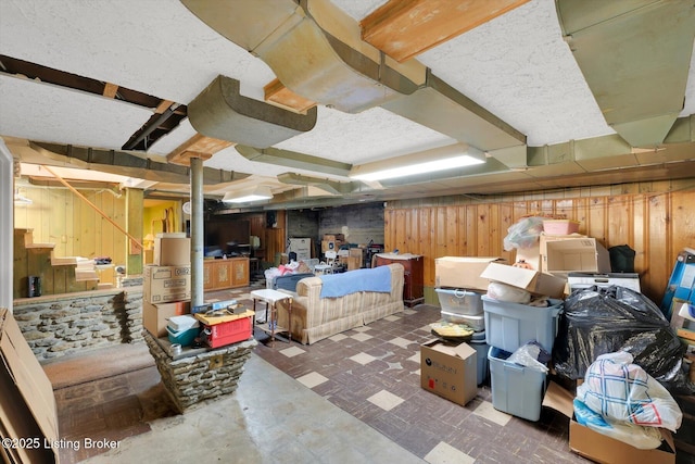 finished basement with stairway and wood walls