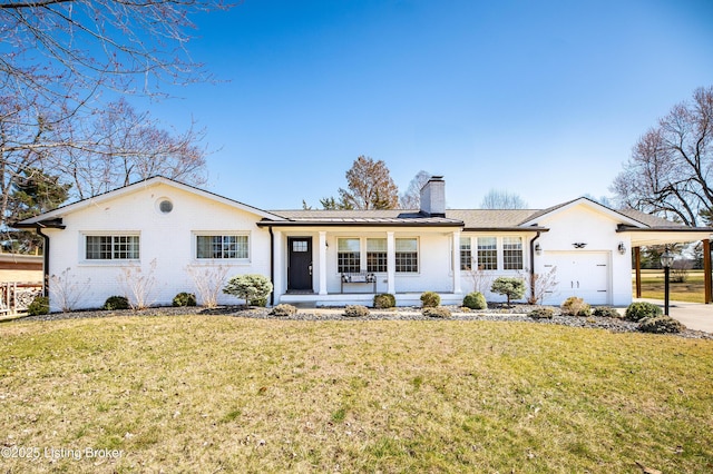 ranch-style house with a front lawn, brick siding, a garage, and a chimney