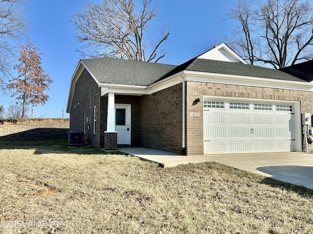 view of property exterior with brick siding, concrete driveway, central AC, a yard, and an attached garage